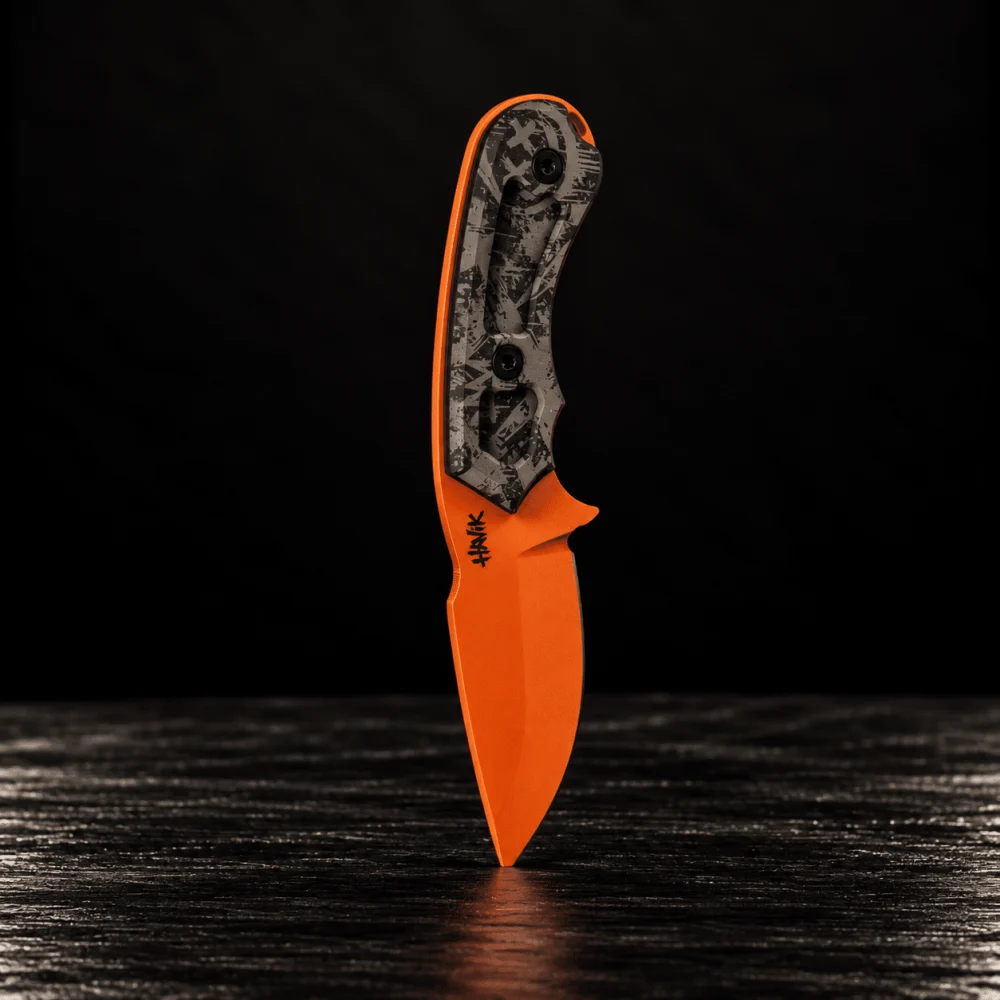 Rare Breed knife with an orange blade and camo handle, standing on its tip