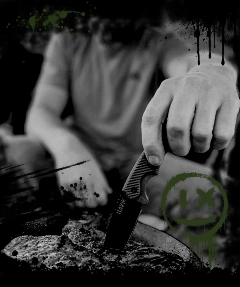 Hand cutting meat at a campfire with a HAViK fixed-blade knife